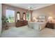 Comfortable bedroom with a ceiling fan, carpet floors, a dresser, and bright windows for ample natural light at 5560 Squires Dr, Leesburg, FL 34748