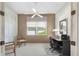 Office space featuring a ceiling fan, window, desk setup, and closet for ample storage at 5560 Squires Dr, Leesburg, FL 34748