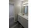 Bright bathroom featuring a modern vanity with white cabinets and a large mirror at 609 Whittingham Pl, Lake Mary, FL 32746