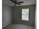 Standard bedroom with ceiling fan, neutral paint, and a large window with blinds at 609 Whittingham Pl, Lake Mary, FL 32746