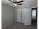 Carpeted bedroom with a closet and an open door showcasing a view to another room at 609 Whittingham Pl, Lake Mary, FL 32746