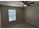 Neutral bedroom featuring a ceiling fan and a window that brings in natural light at 609 Whittingham Pl, Lake Mary, FL 32746