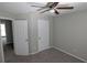 Bedroom with ceiling fan, neutral color, and doors leading to additional rooms at 609 Whittingham Pl, Lake Mary, FL 32746