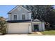 Charming two-story home featuring a two-car garage, gray stucco and dark green door at 609 Whittingham Pl, Lake Mary, FL 32746