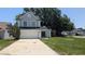 Charming two-story home featuring a two-car garage, gray stucco and dark green door at 609 Whittingham Pl, Lake Mary, FL 32746