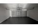 Spacious garage with a large door and a clean, painted floor for easy maintenance at 609 Whittingham Pl, Lake Mary, FL 32746