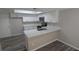 Modern kitchen featuring white cabinetry, quartz countertops, and stainless steel appliances at 609 Whittingham Pl, Lake Mary, FL 32746