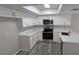 Modern kitchen featuring white cabinetry, quartz countertops, and stainless steel appliances at 609 Whittingham Pl, Lake Mary, FL 32746