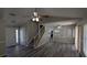 A spacious living room with wood floors, staircase and a view into the kitchen at 609 Whittingham Pl, Lake Mary, FL 32746