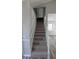 Carpeted staircase leads to upper level with modern trim, painted in neutral colors at 609 Whittingham Pl, Lake Mary, FL 32746
