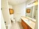 Bathroom with tile flooring, wooden cabinets, and shower with bathtub at 6169 Metrowest Blvd # 308, Orlando, FL 32835