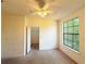 Bright bedroom with large window and ceiling fan, leading into closet space at 6169 Metrowest Blvd # 308, Orlando, FL 32835
