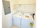 Cozy laundry area equipped with a functional washer and dryer setup at 6169 Metrowest Blvd # 308, Orlando, FL 32835