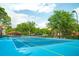 Brightly painted community tennis court with net at 6169 Metrowest Blvd # 308, Orlando, FL 32835