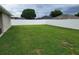 Spacious backyard with green grass enclosed by a white vinyl privacy fence for outdoor activities at 6800 Se 12Th Pl, Ocala, FL 34472