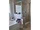Bright bathroom with a soaking tub and a glass enclosed shower at 6800 Se 12Th Pl, Ocala, FL 34472
