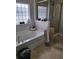 Bright bathroom featuring a soaking tub, glass shower, and neutral toned tile flooring at 6800 Se 12Th Pl, Ocala, FL 34472