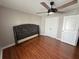 A bedroom with hardwood floors, ceiling fan, and modern decor at 6800 Se 12Th Pl, Ocala, FL 34472