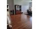 Open dining area with hardwood floors, modern light fixture, display cabinet, and view to the kitchen at 6800 Se 12Th Pl, Ocala, FL 34472
