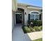 Inviting front entrance featuring a dark door, manicured landscaping, and a decorative lion statue at 6800 Se 12Th Pl, Ocala, FL 34472