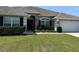 Charming single-story home with a well-manicured lawn and inviting curb appeal, complemented by lush landscaping at 6800 Se 12Th Pl, Ocala, FL 34472