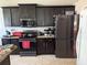 Functional kitchen featuring sleek, dark cabinetry, modern appliances, and ample counter space for cooking at 6800 Se 12Th Pl, Ocala, FL 34472