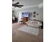 Cozy living room featuring a decorative rug, ceiling fan, flat screen tv, and comfortable couch at 6800 Se 12Th Pl, Ocala, FL 34472