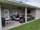 Covered patio with an outdoor living area featuring comfortable seating and a ceiling fan at 6800 Se 12Th Pl, Ocala, FL 34472
