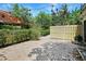 Backyard area features greenery, a brick-paved space, and a wooden fence at 6941 Piazza St, Orlando, FL 32819
