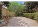 Backyard area features greenery, a brick-paved space, and a wooden fence at 6941 Piazza St, Orlando, FL 32819