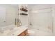 Bright bathroom features a vanity with a sink, a toilet, and a bathtub with sliding glass doors at 6941 Piazza St, Orlando, FL 32819