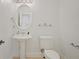 Bathroom features a vanity with sink, a toilet, a mirror, and hardware in silver at 6941 Piazza St, Orlando, FL 32819