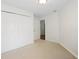 Empty bedroom features carpet, closet and light-colored walls at 6941 Piazza St, Orlando, FL 32819