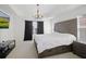 Large primary bedroom with a trey ceiling and a picture window at 6941 Piazza St, Orlando, FL 32819