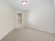 Empty bedroom features neutral carpet, one window with blinds, and light-colored walls at 6941 Piazza St, Orlando, FL 32819