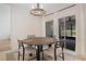 Cozy dining area with slider access to the screened lanai, and seating for four at 6941 Piazza St, Orlando, FL 32819