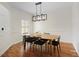 Well-lit dining room with wood floors, modern chandelier, and stylish furnishings at 6941 Piazza St, Orlando, FL 32819