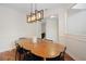 Bright dining area with wood flooring, a stylish light fixture, and ample space at 6941 Piazza St, Orlando, FL 32819