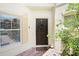 Inviting front entrance with a wreath, lovely plants, and a window with white blinds at 6941 Piazza St, Orlando, FL 32819
