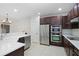 Modern kitchen with stainless steel appliances, dark cabinets, and bright white countertops at 6941 Piazza St, Orlando, FL 32819