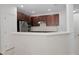 Spacious kitchen featuring dark wood cabinetry, stainless steel appliances, and a breakfast bar at 6941 Piazza St, Orlando, FL 32819