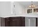 Kitchen featuring stainless steel appliances, a breakfast bar, and dark wood cabinets at 6941 Piazza St, Orlando, FL 32819