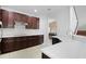 Open kitchen showcasing stainless steel appliances, a breakfast bar, and dark wood cabinetry at 6941 Piazza St, Orlando, FL 32819