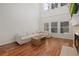 Open living room area with hardwood floors and many windows at 6941 Piazza St, Orlando, FL 32819