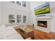 Bright living room with a fireplace and lots of natural light from large windows at 6941 Piazza St, Orlando, FL 32819