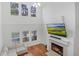 Bright living room with a fireplace, hardwood floors, and lots of natural light from large windows at 6941 Piazza St, Orlando, FL 32819
