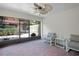A screened-in patio with brick floors features seating and views of greenery at 6941 Piazza St, Orlando, FL 32819
