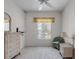 Bedroom with a window view, ceiling fan, and light carpet at 6955 Della Dr # 41, Orlando, FL 32819
