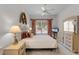 Bright bedroom featuring a ceiling fan, a queen bed, and decorative touches at 6955 Della Dr # 41, Orlando, FL 32819