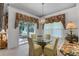 Bright dining area with a glass-top table and view of the outdoors at 6955 Della Dr # 41, Orlando, FL 32819